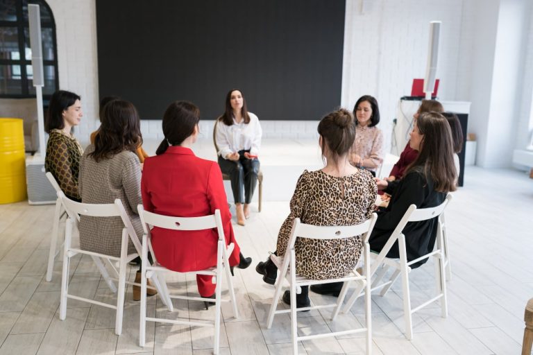 a group of women sitting in chairs in a circle - 12 step meetings in irvine