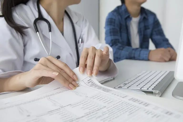 a doctor holding insurance papers