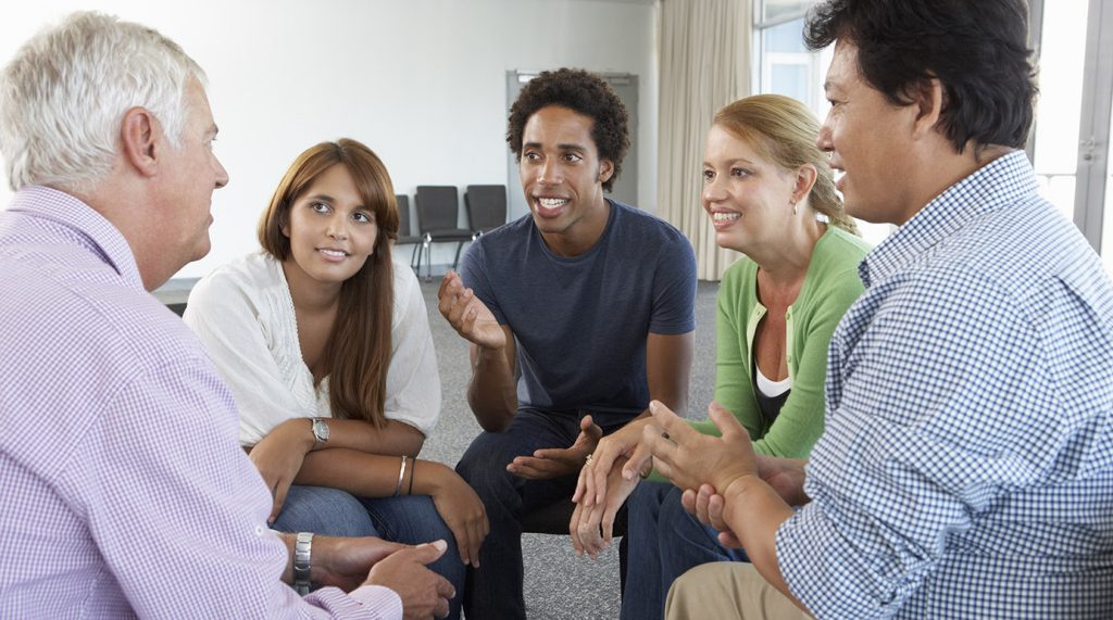 a group of people sitting in a circle