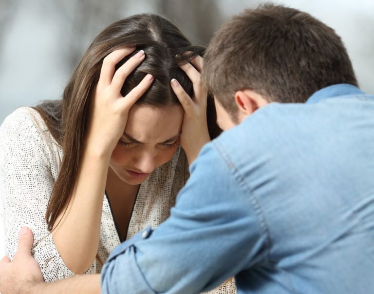 a man holding a woman's head