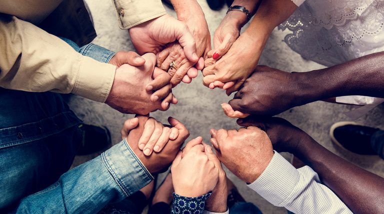 a group of people holding hands