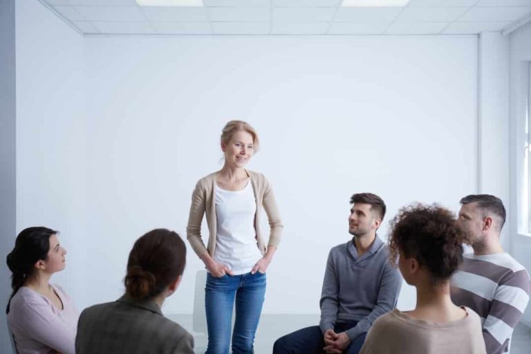 a woman standing in front of a group of people